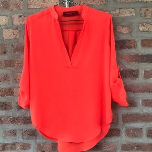 Small bright orange Akira top
